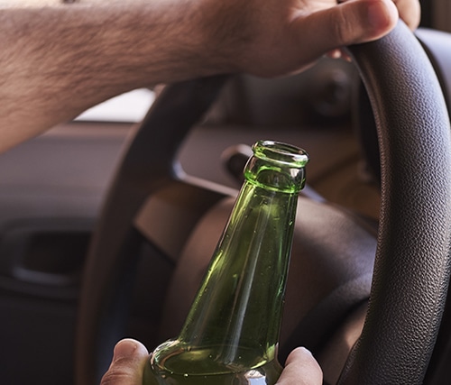 Holding a beer bottle while driving